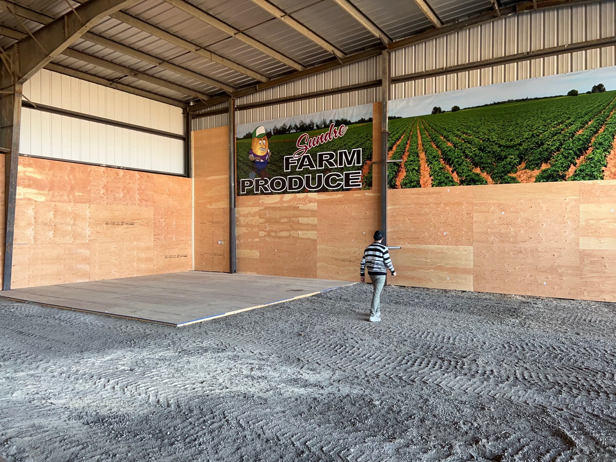 Farm produce banner installed in a barn